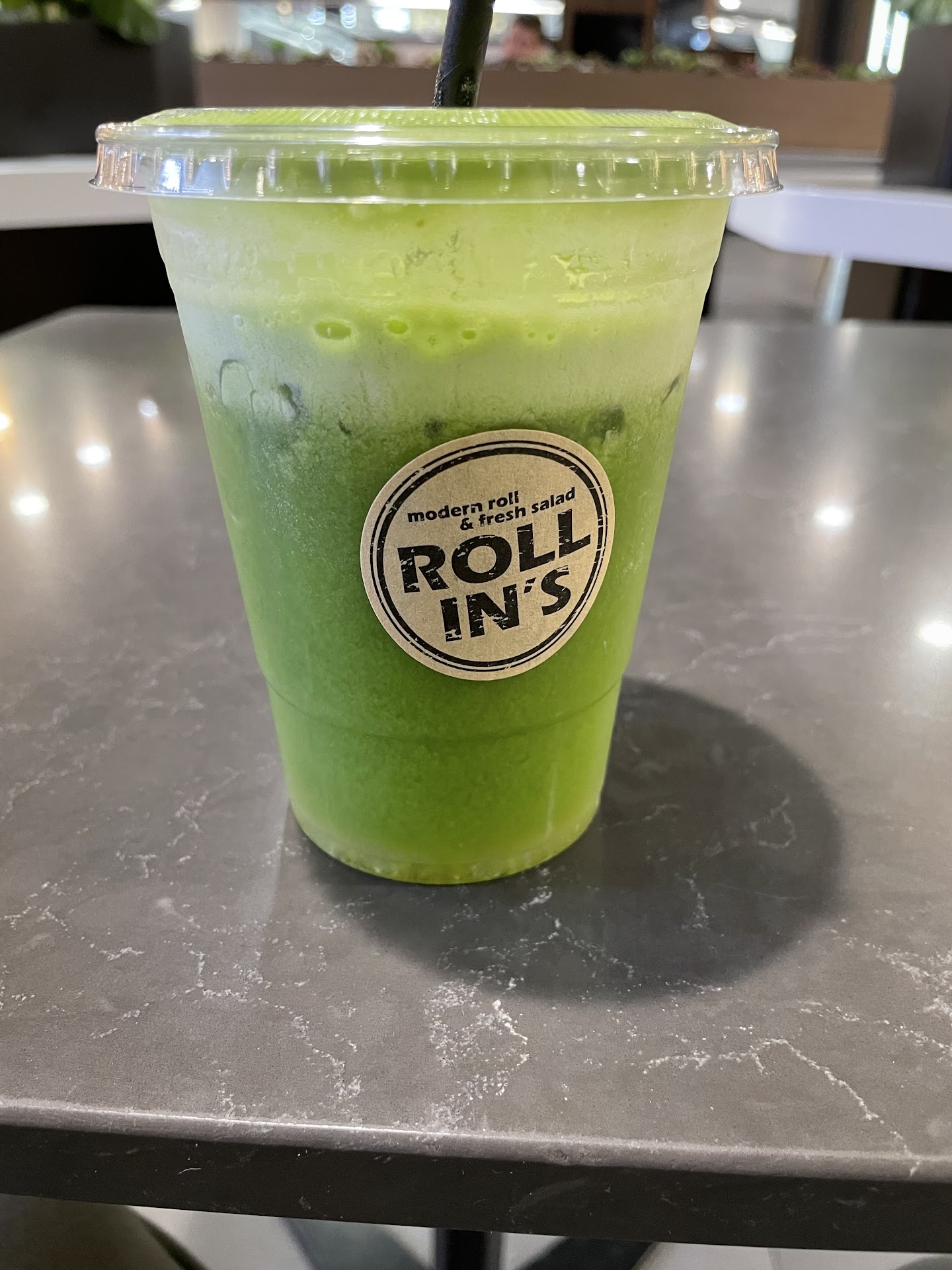 Green juice in a Rollin's branded cup
